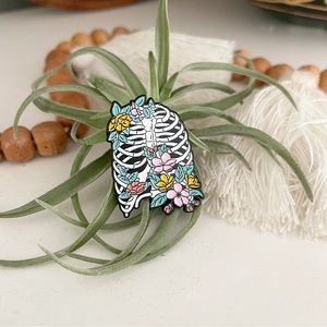Planty rib cage skeleton metal pin. Brand new!